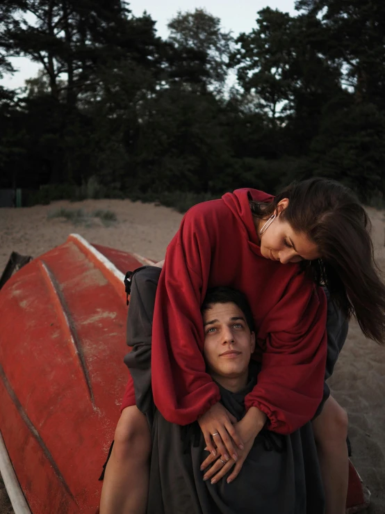 a man riding a woman on the back of a boat, by Attila Meszlenyi, trending on unsplash, wearing a scarlet hoodie, ignant, late summer evening, hugging each other