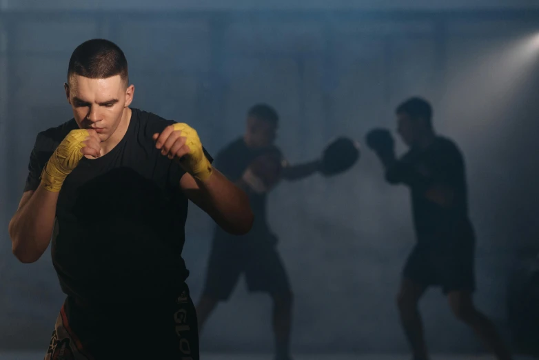 a man in a black shirt and yellow boxing gloves, pexels contest winner, vfx action shot, background image, full-body, sweat