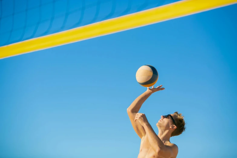 a man reaching up to hit a volleyball ball, clear blue skies, manly, profile image, sunburn
