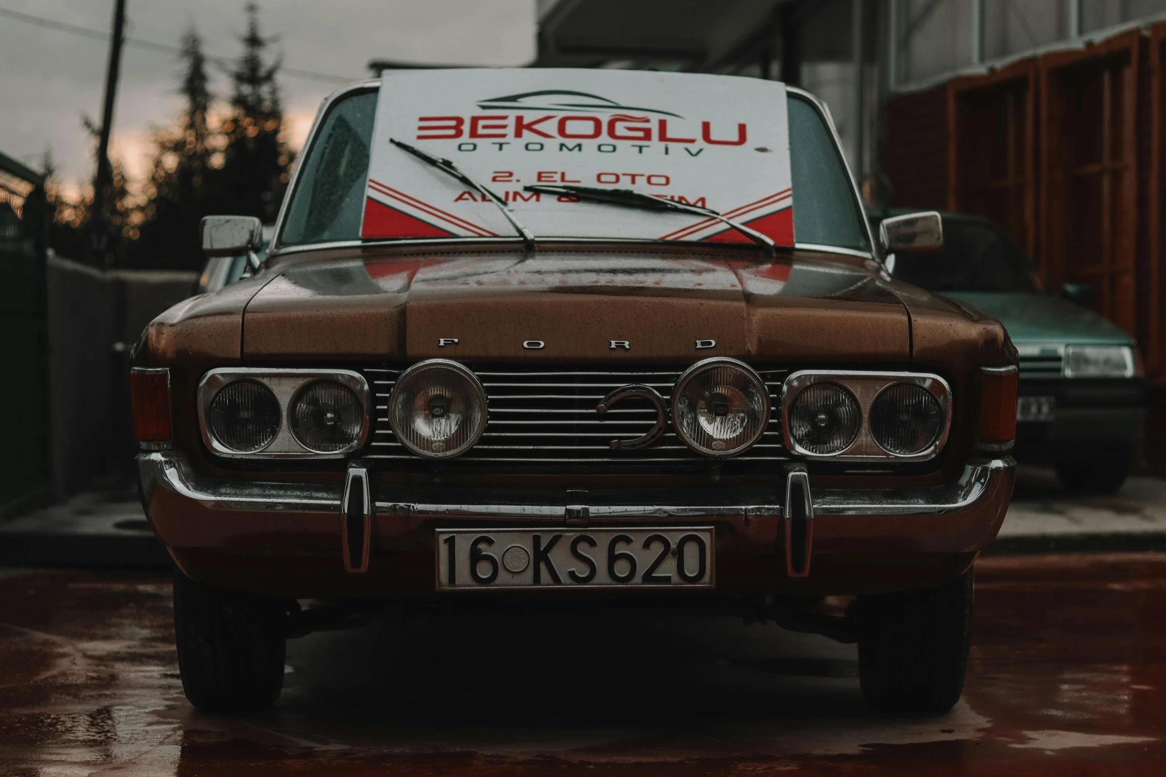 a brown car parked in front of a building, by Edwin Georgi, pexels contest winner, decorated with soviet motifs, 🚿🗝📝, commercial banner, gelbooru