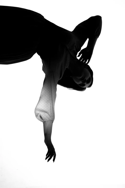 a black and white photo of a woman doing a handstand, an album cover, by Clifford Ross, unsplash, conceptual art, horse legs and human body, lit from below, veins merged feet head, glassy fracture