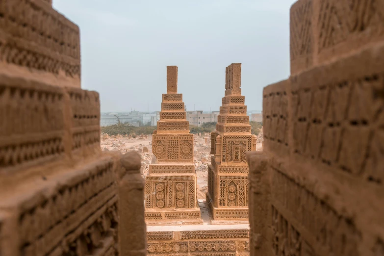 a view of a city from the top of a building, a detailed matte painting, pexels contest winner, visual art, sand sculpture, stacked city, oman, obelisks