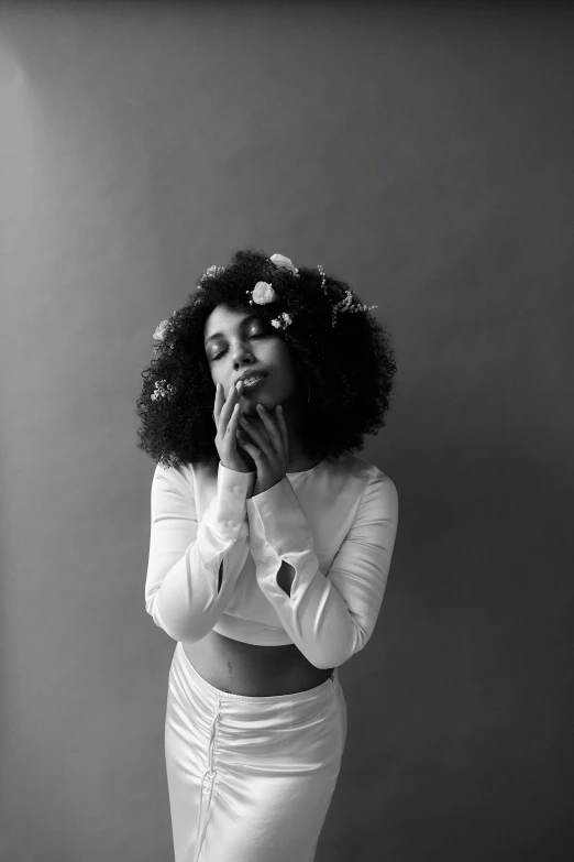 a black and white photo of a woman in a dress, a black and white photo, by Adélaïde Victoire Hall, unsplash, long afro hair, female portrait with flowers, in white clothes, various pose