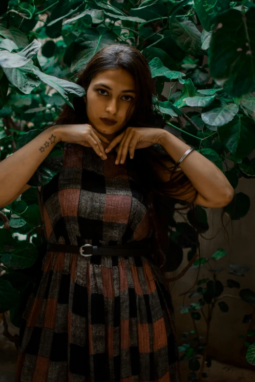 a woman making a heart sign with her hands, an album cover, inspired by Elsa Bleda, trending on pexels, renaissance, indian girl with brown skin, with ivy, ((portrait)), assamese aesthetic