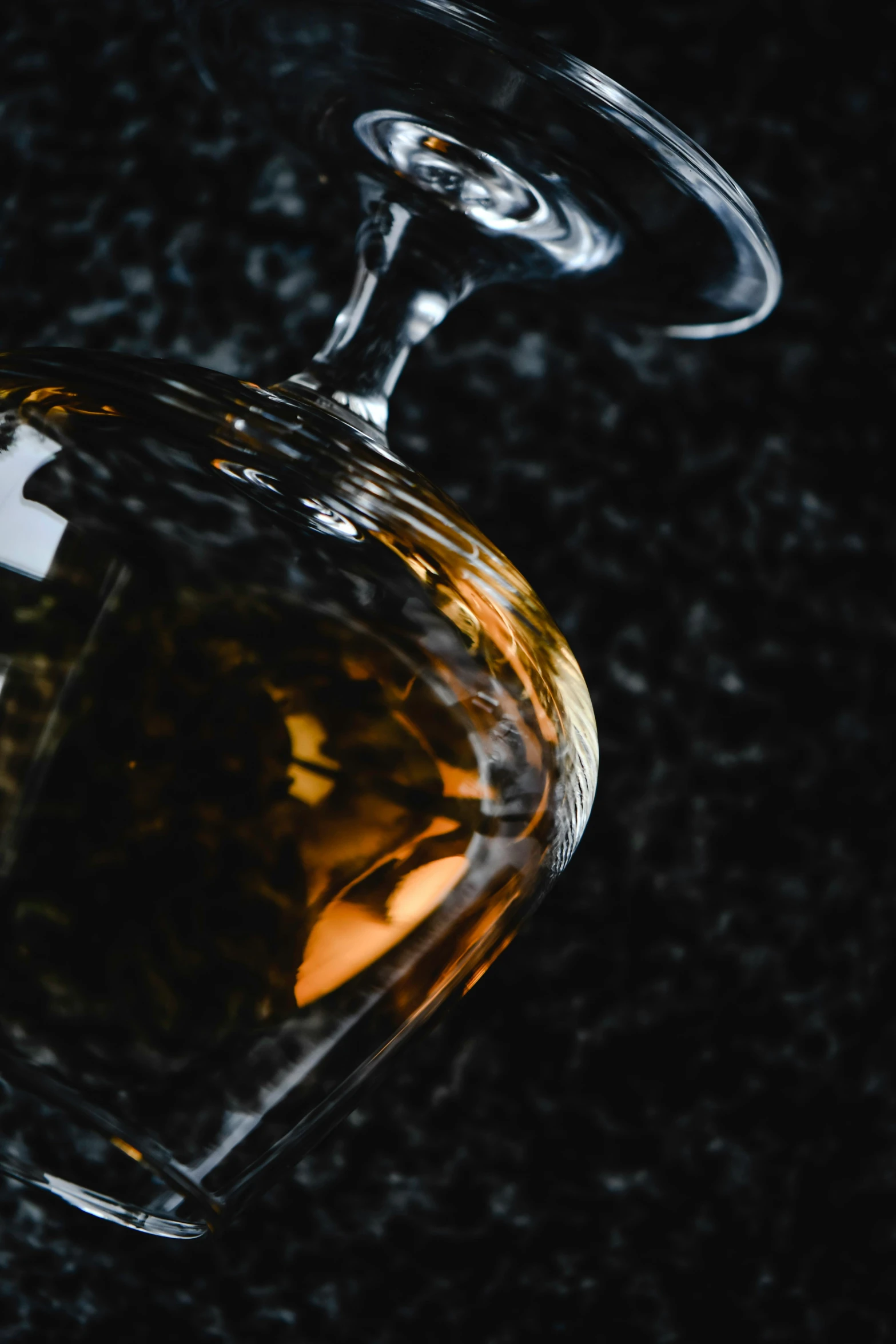a bottle of alcohol sitting on top of a counter, by Daniel Seghers, unsplash, renaissance, on black background, molten glass, close-up product photo, clear curvy details