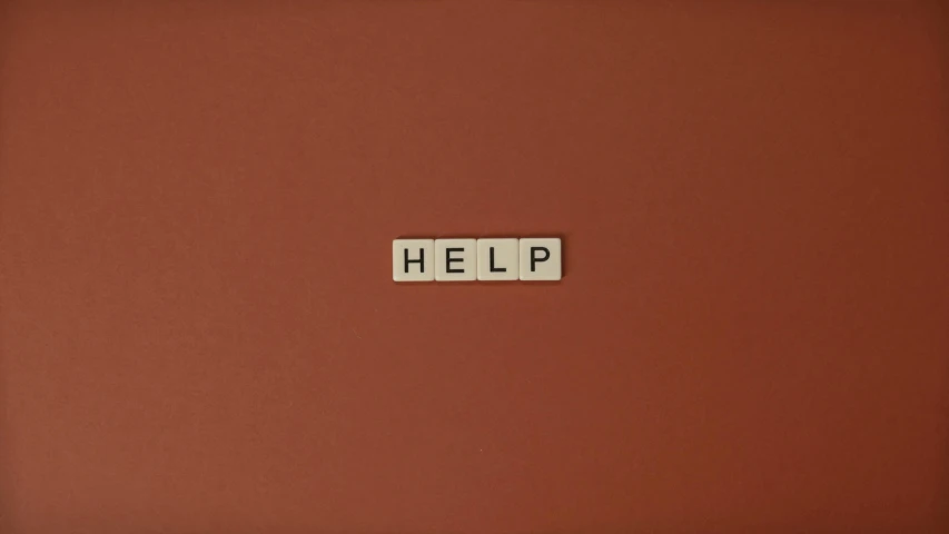 a tile with the word help written on it, an album cover, by Francis Helps, pexels, terracotta, taupe, addiction, television still