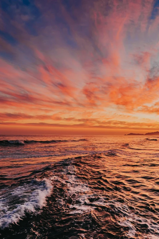 a sunset over the ocean with waves in the foreground, vibrantly colorful, photo taken from a boat, 2 5 6 x 2 5 6 pixels, unsplash photo contest winner