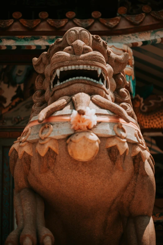 a statue of a lion in front of a building, inspired by Li Kan, pexels contest winner, sumatraism, vietnamese temple scene, close up front view, dragon mouth, brown