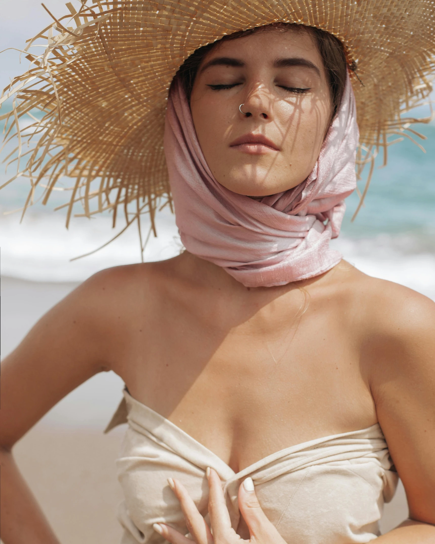 a woman wearing a straw hat on the beach, a colorized photo, inspired by Bunny Yeager, trending on unsplash, renaissance, wearing a scarf, dua lipa, her skin is light brown, wearing translucent sheet