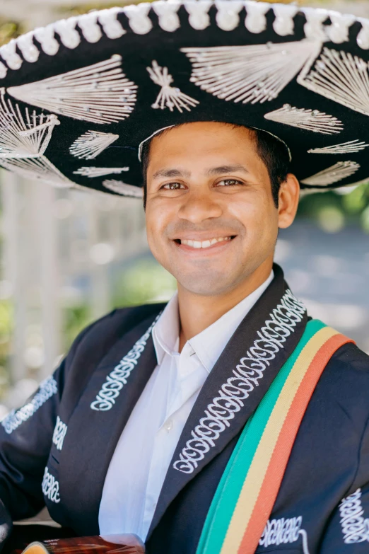 a man wearing a mexican hat and holding a guitar, professional profile picture, wearing presidential band, nivanh chanthara, lgbtq