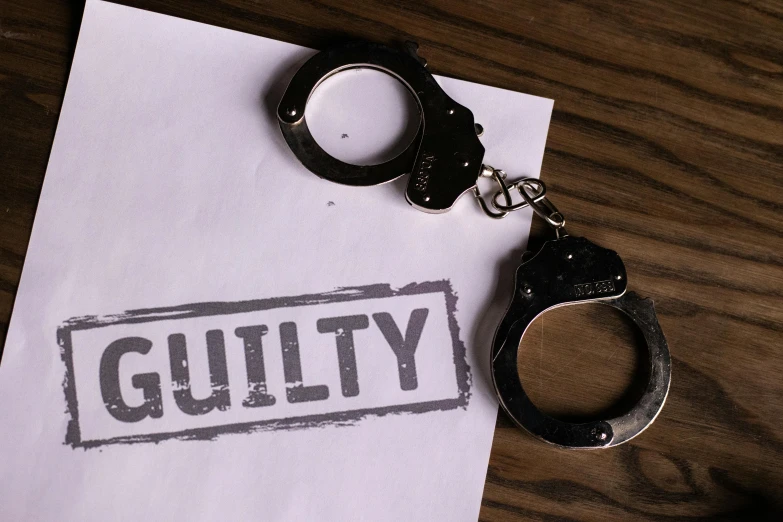 a pair of handcuffs sitting on top of a piece of paper, profile image, guilty gear, a wooden, background image