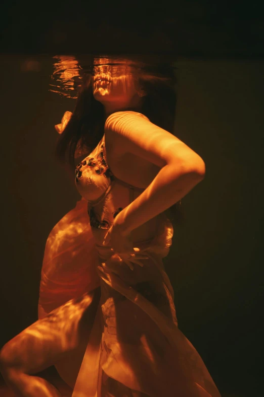 a woman in a white dress under water, an album cover, inspired by Anna Füssli, renaissance, flames around body, taken in the mid 2000s, showstudio, performing on stage