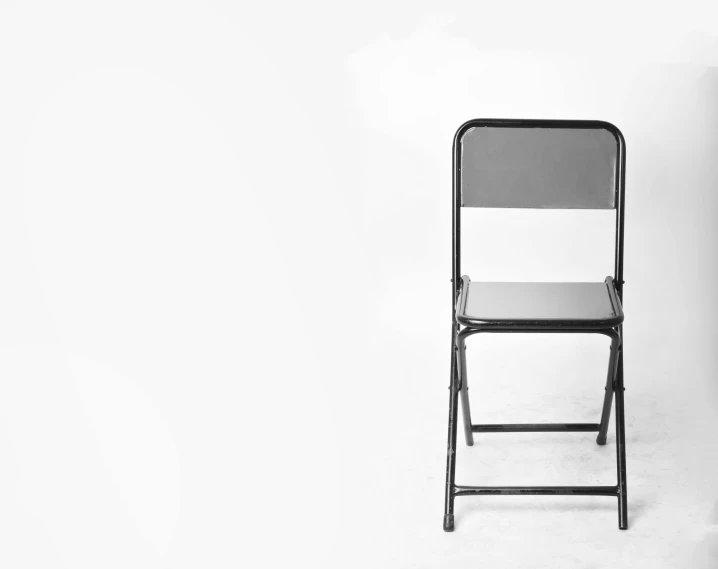 a black and white photo of a folding chair, a portrait, postminimalism, metal readymade, vintage - w 1 0 2 4, minimalistic!! simple, sittin