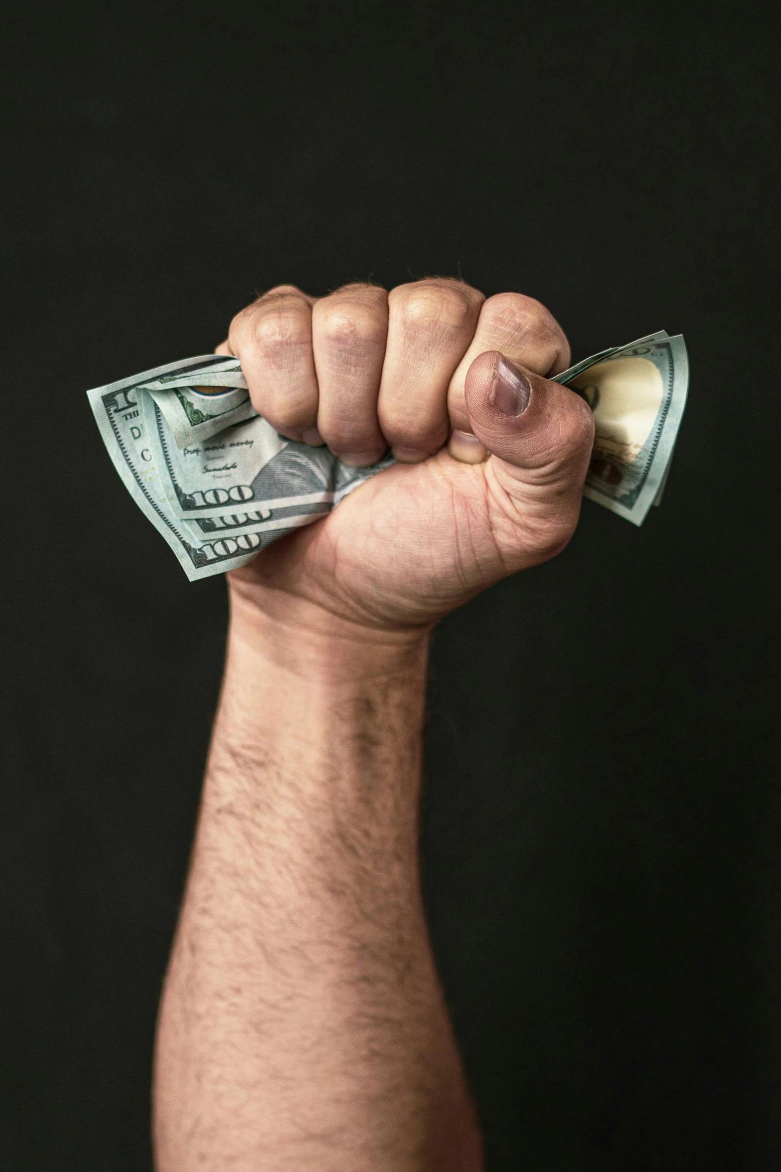 a man holding a bunch of money in his hand, an album cover, pexels, clenched fist, 12, bl, brett goldstein