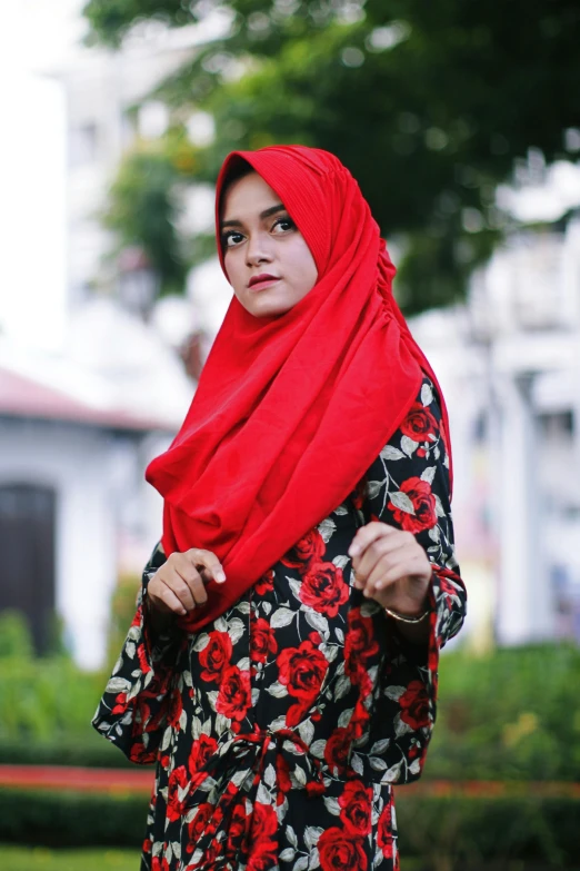 a woman in a red hijab poses for a picture, pexels contest winner, red floral dress, square, serious, red - black