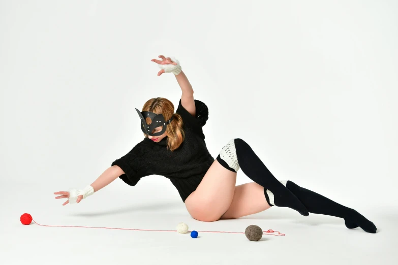 a woman in a mask is playing with a ball, an album cover, inspired by Hans Bellmer, unsplash, furry art, ayaka cosplay, 15081959 21121991 01012000 4k, lying dynamic pose, halloween