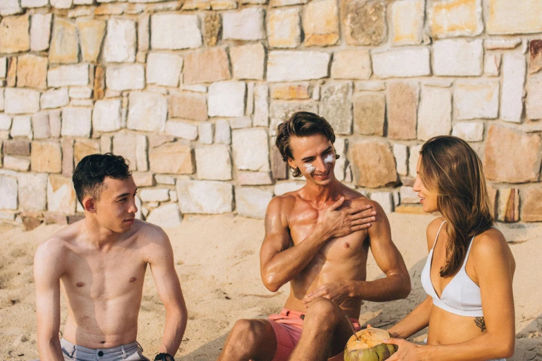 a group of people sitting on top of a sandy beach, sweaty skin, avatar image, guillaume tholly, skincare