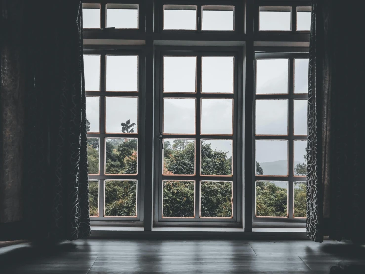 a black and white photo of an open window, unsplash contest winner, arts and crafts movement, moody muted colors, peaceful wooden mansion, lush vista, in the middle of an empty room