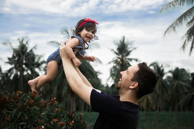 a man holding a little girl up in the air, pexels contest winner, symbolism, avatar image, malaysian, dad bod, a still of a happy