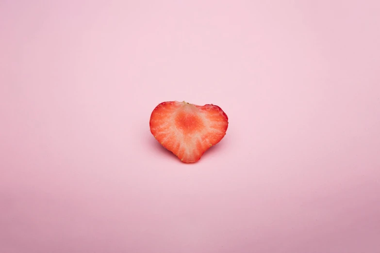 a strawberry in the shape of a heart on a pink background, by Elsa Bleda, pexels, minimalism, ffffound, rinko kawauchi, cooked, single light