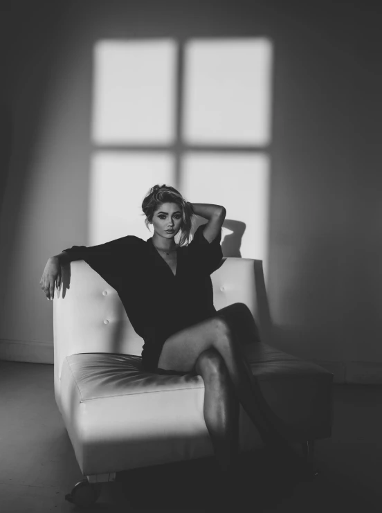 a black and white photo of a woman sitting in a chair, light and space, instagram photo shoot, trending on imagestation, androgyny, elegant posed