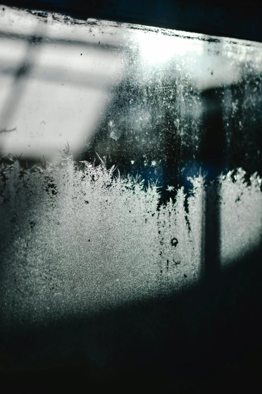 a close up of a window with frost on it, inspired by Elsa Bleda, pexels contest winner, abstract expressionism, dark city bus stop, water stains, inside of a car, looking sad