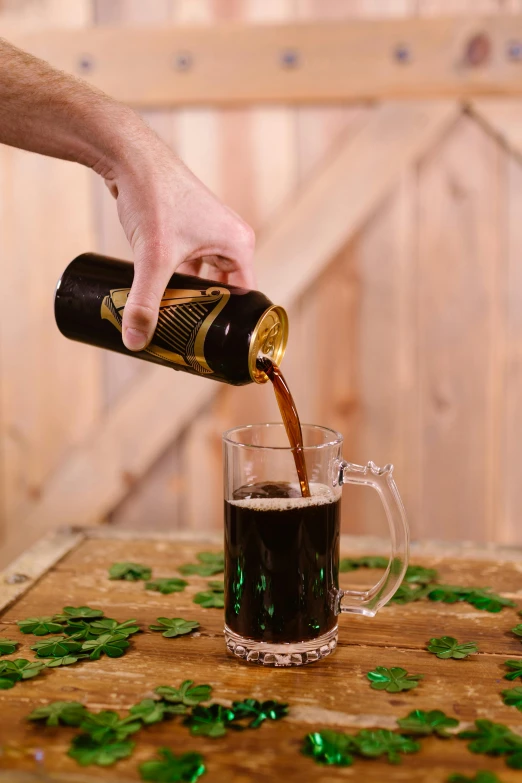 a person pouring a beer into a glass, black and brown, irish, fully covered, base