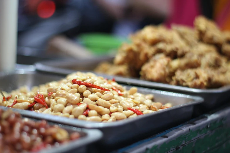 a close up of trays of food on a table, a photo, unsplash, fantastic realism, south jakarta, baked beans, square, sichuan