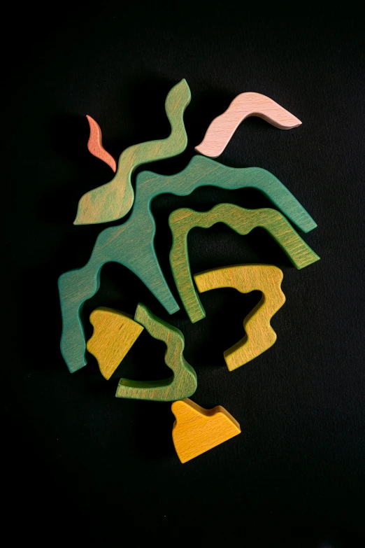 a group of wooden toys sitting on top of a table, inspired by Jean Arp, unsplash, process art, reefs, river delta, on black background, colorful ravine