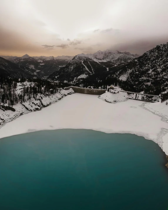 a body of water surrounded by snow covered mountains, dolomites, pools of water, water reservoir, trending photo