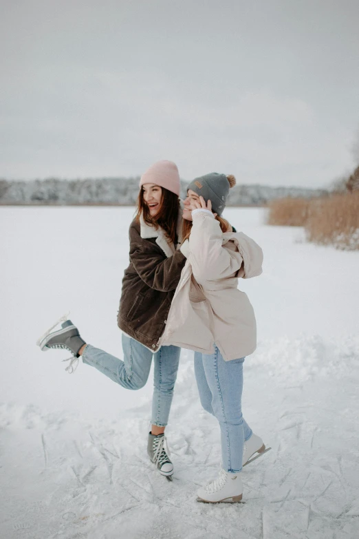 two women standing next to each other in the snow, a picture, trending on pexels, playful pose, wearing casual clothing, gif, sk