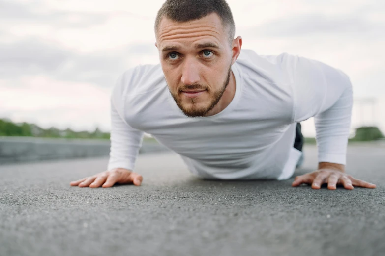 a man doing push ups on the ground, pexels contest winner, hyperrealism, avatar image, square jaw-line, background image, looking straight into camera