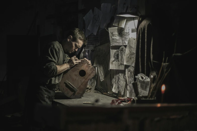 a man working on a guitar in a dark room, an album cover, pexels contest winner, australian tonalism, professional woodcarving, weta disney movie still photo, profile picture, blacksmith