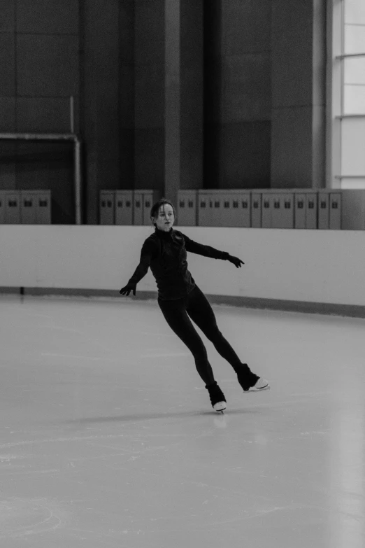 a man riding a skateboard on top of an ice rink, a black and white photo, arabesque, she is floating in the air, wearing a track suit, in a white room, kai vermehr