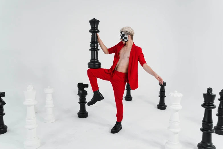 a man in a red suit playing a game of chess, an album cover, inspired by Horace Vernet, pexels contest winner, full body photoshoot, xqc, in spandex suit, pose 4 of 1 6