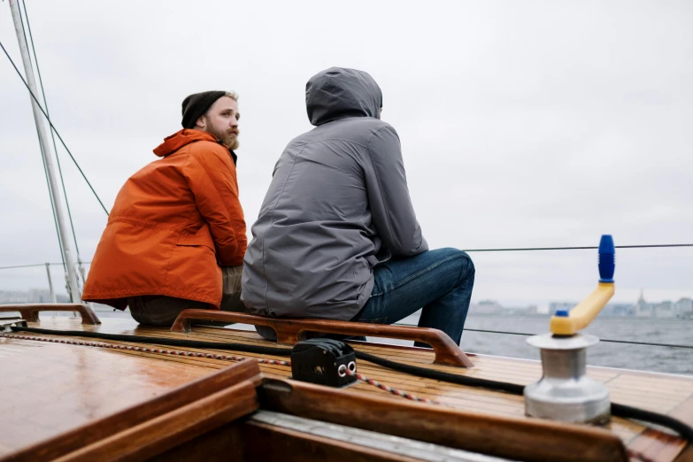 a couple of people that are sitting on a boat, by Jaakko Mattila, unsplash, happening, slight overcast weather, look at the details, a wooden, sean mcloughlin