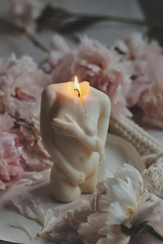 a white candle sitting on top of a white plate, a marble sculpture, inspired by Elsa Bleda, romanticism, loving embrace, albino mystic, entwined bodies, blushing