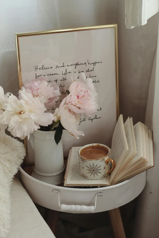 a white table topped with a book and a cup of coffee, poster art, romanticism, peonies, calligraphic poetry, trending photo, someone in home sits in bed
