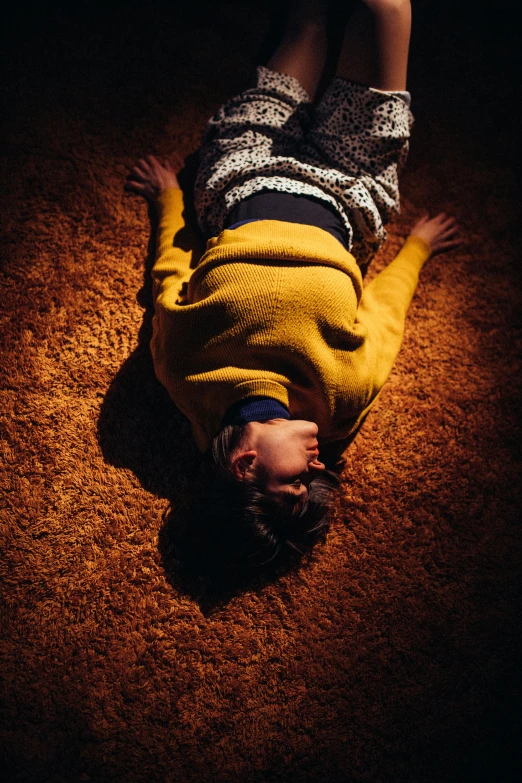 a person laying on the floor in the dark, yellow carpeted, frank moth, dolman, deep colour