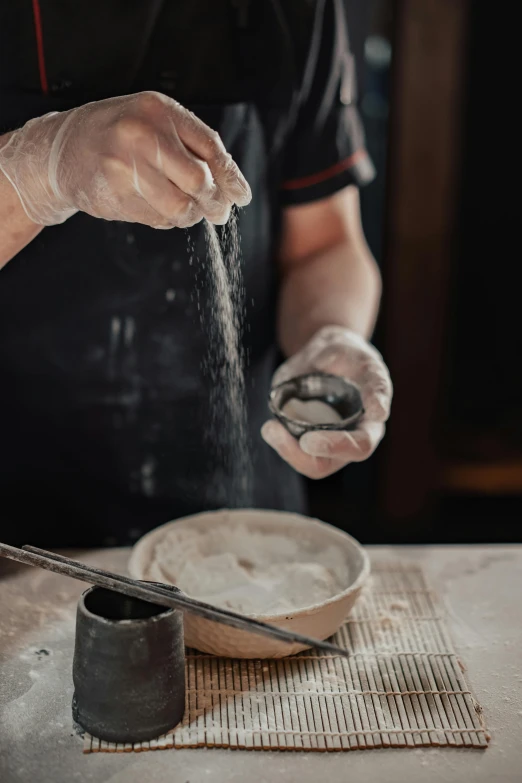 a chef is sprinkling flour into a bowl, a charcoal drawing, inspired by Kanō Naizen, trending on pexels, arbeitsrat für kunst, clay model, jewelry, unfinished, thumbnail