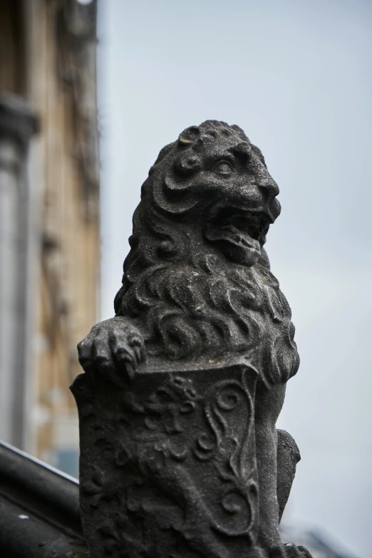 a statue of a lion on top of a building