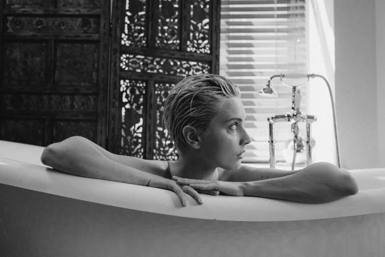 a black and white photo of a woman in a bathtub, amber heard, short platinum hair tomboy, bali, square