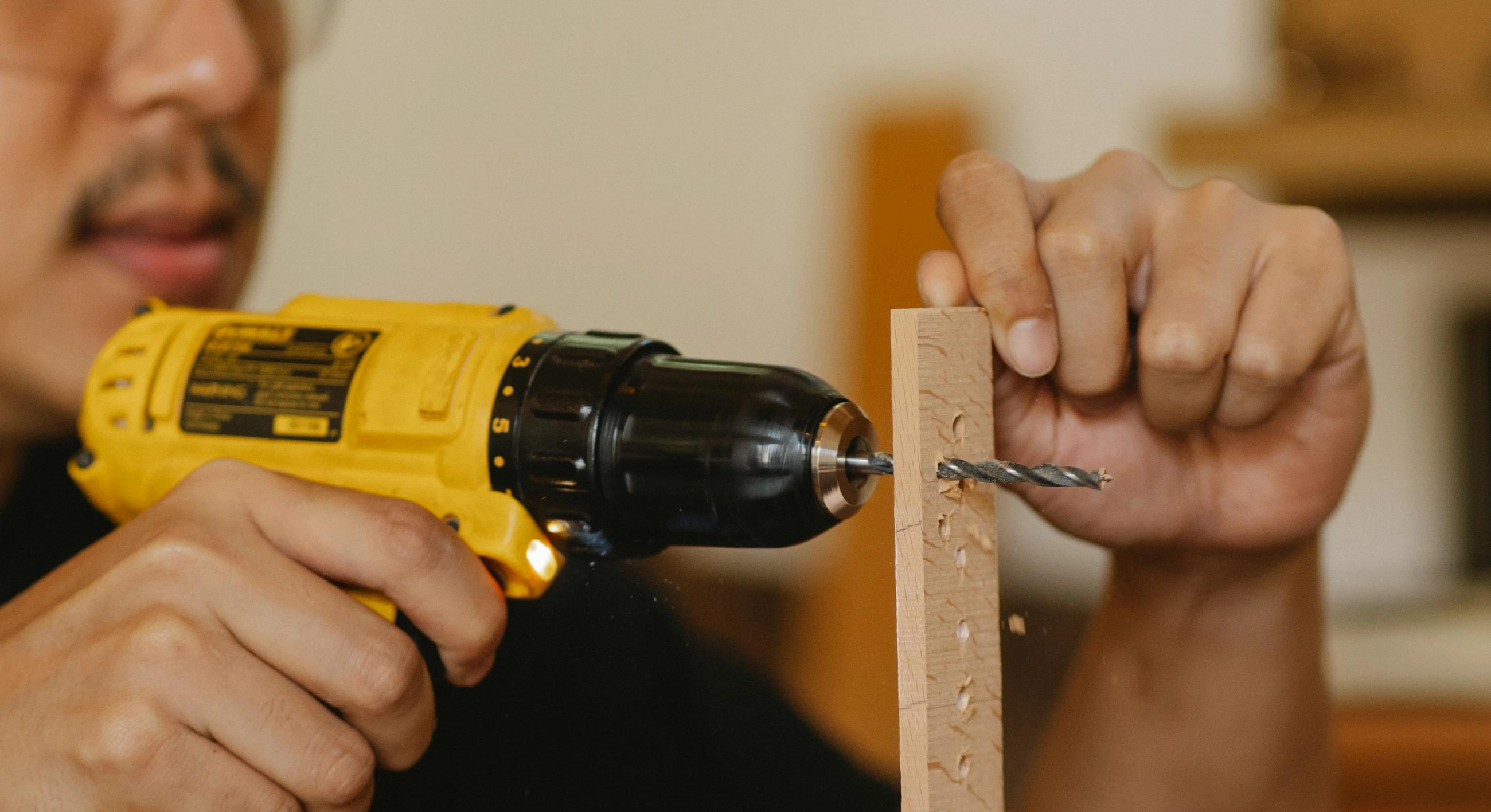 a man drilling a piece of wood with a drill, pexels contest winner, holding a yellow toothbrush, 🦑 design, homemade, rectangle