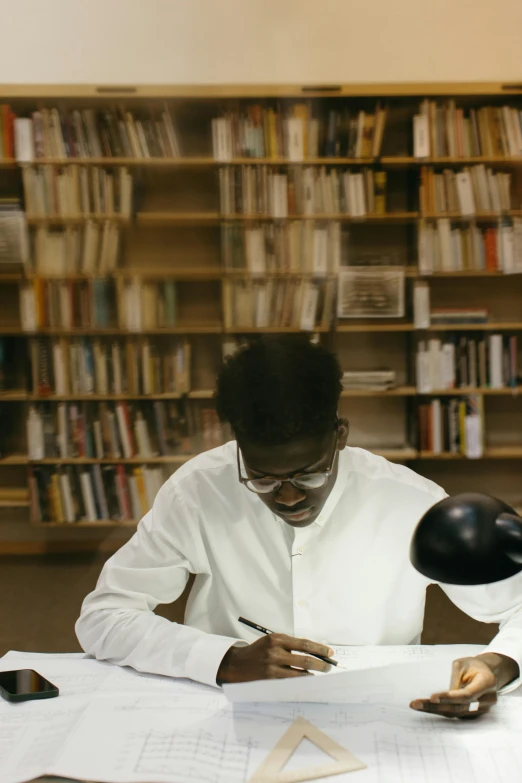 a man that is sitting at a table with a lamp, an album cover, by Barthélemy Menn, pexels contest winner, academic art, inside a library, african, olafur eliasson, still frame from a movie