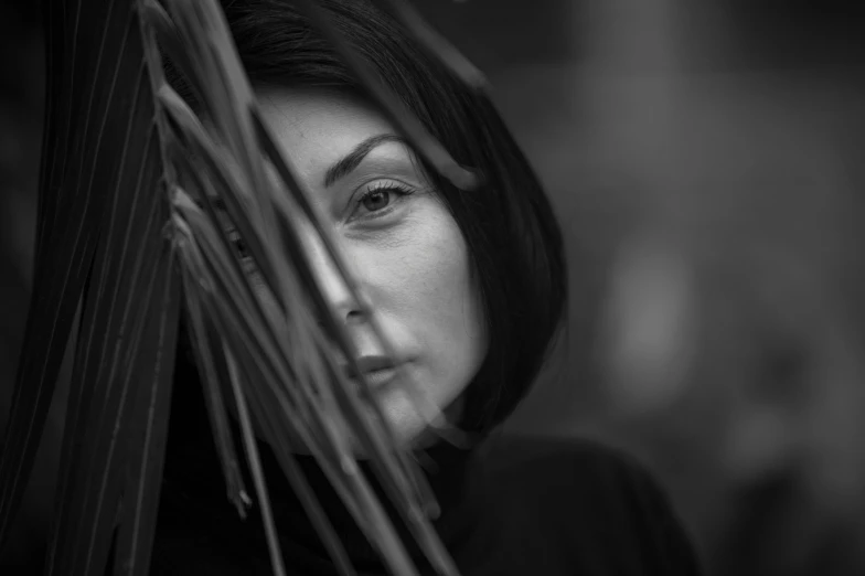 a black and white photo of a woman, a black and white photo, by Mathias Kollros, pexels contest winner, hurufiyya, amongst foliage, sarah andersen, color photograph portrait 4k, palm