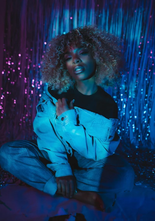 a woman sitting on top of a bed in a room, an album cover, trending on pexels, holography, ashteroth, blue lights, badass pose, silver curly hair