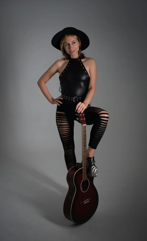 a woman sitting on top of a guitar, inspired by Jack Smith, leather body suit, headshot and bodyshot, cow-girl, full body shot!!