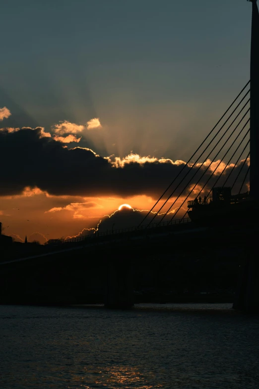 a bridge over a body of water at sunset, by Ian Fairweather, happening, glasgow, rays of sun, dramatic lighting - n 9, morning detail
