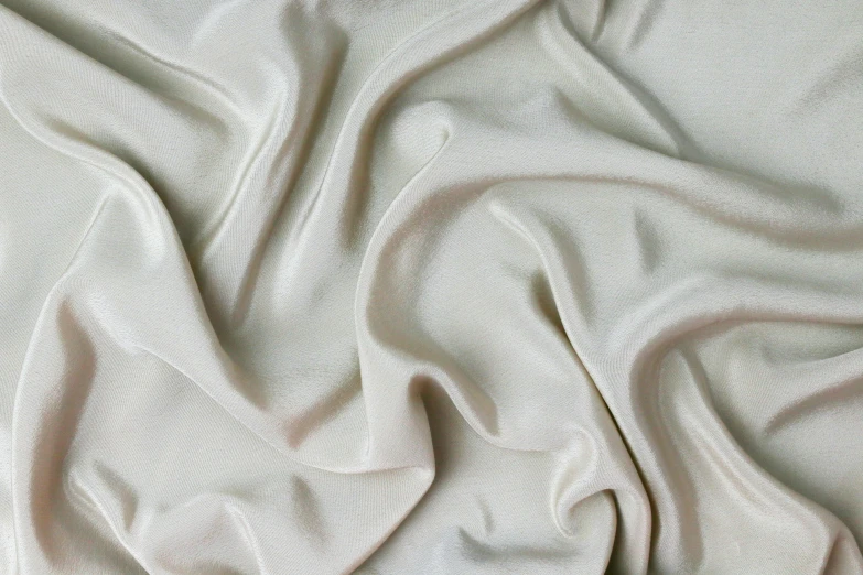 a close up of a white cloth on a bed, inspired by Gian Lorenzo Bernini, trending on pexels, silk dress, birch, pearlescent skin, light grey background