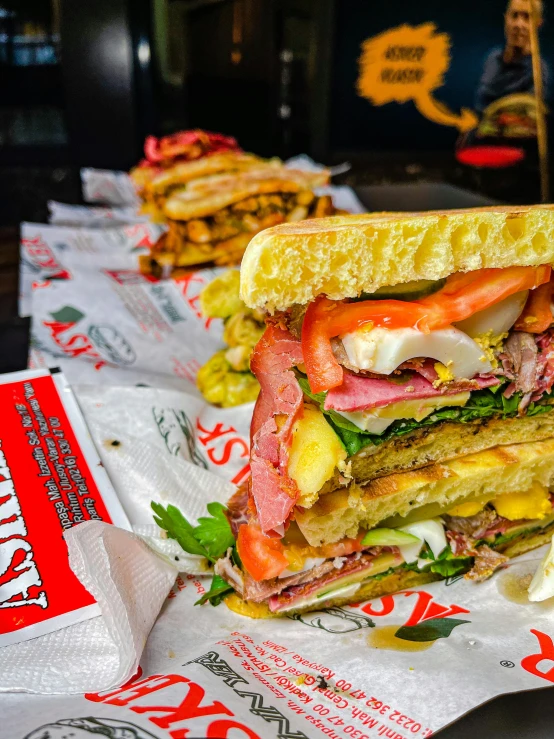 a close up of a sandwich on a table, hustlers, redsinski, stacks, fully decorated